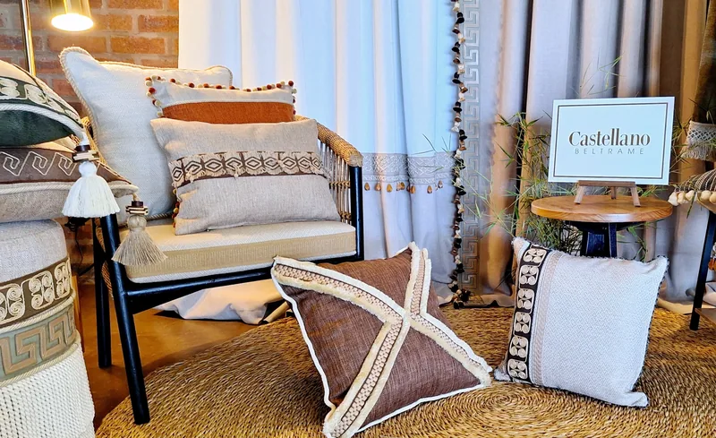Showroom corner styled with Pemba Shingwedzi cushions and trimmed curtains